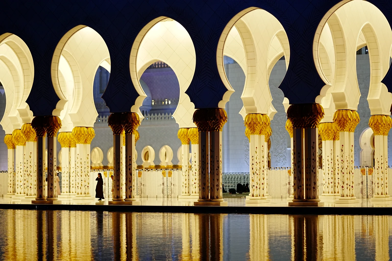 The golden arches of the Sheikh Zayed Grand Mosque at night