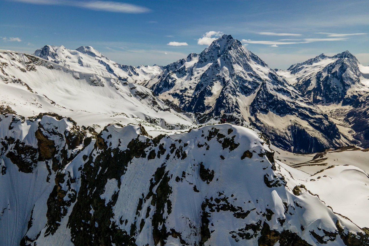 Snow-covered Rocky Mountain peaks under a clear sky