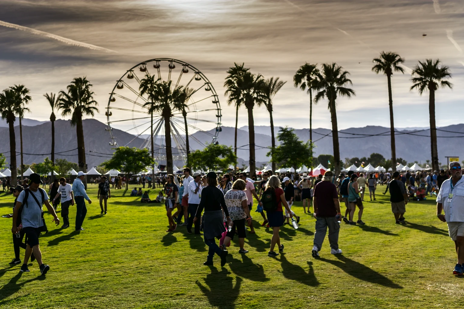 The lawns of the Empire Polo Club in Indio at a festival, the Ferris wheel behind