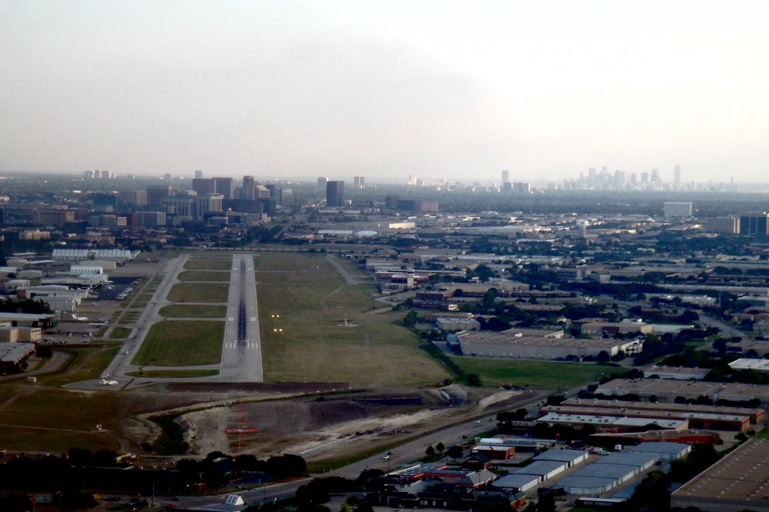 Final approach to Addison's runway, the towers of North Dallas and downtown on the horizon