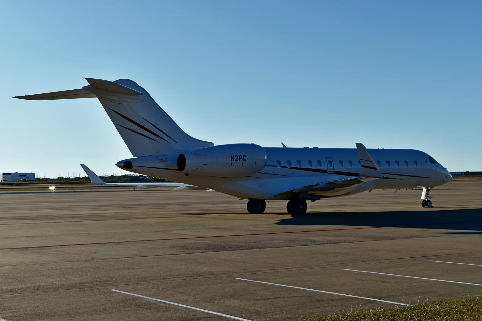 A Bombardier Global Express XRS on the ramp at Alliance in low sun