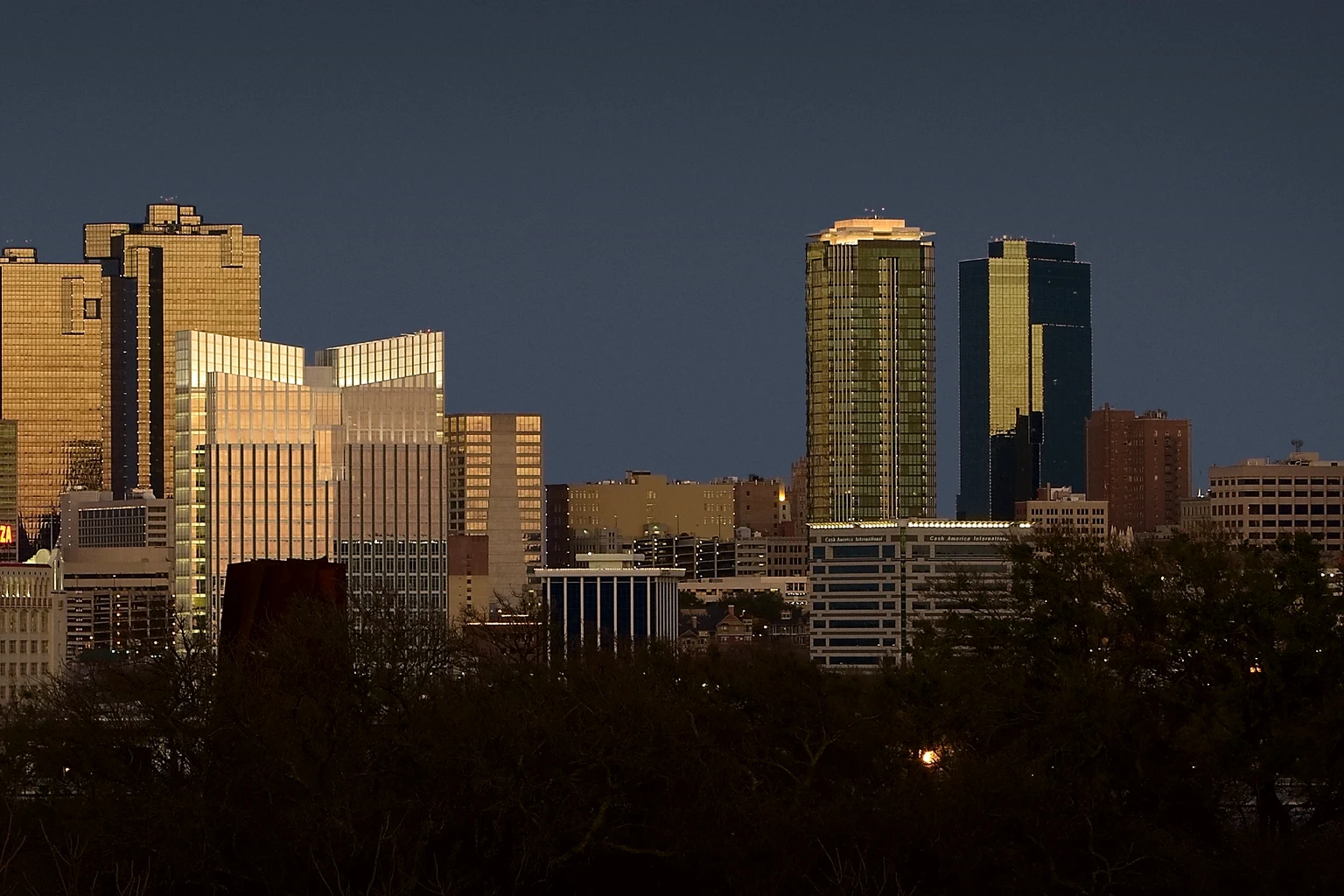 Downtown Fort Worth's towers lit gold under a dark sky