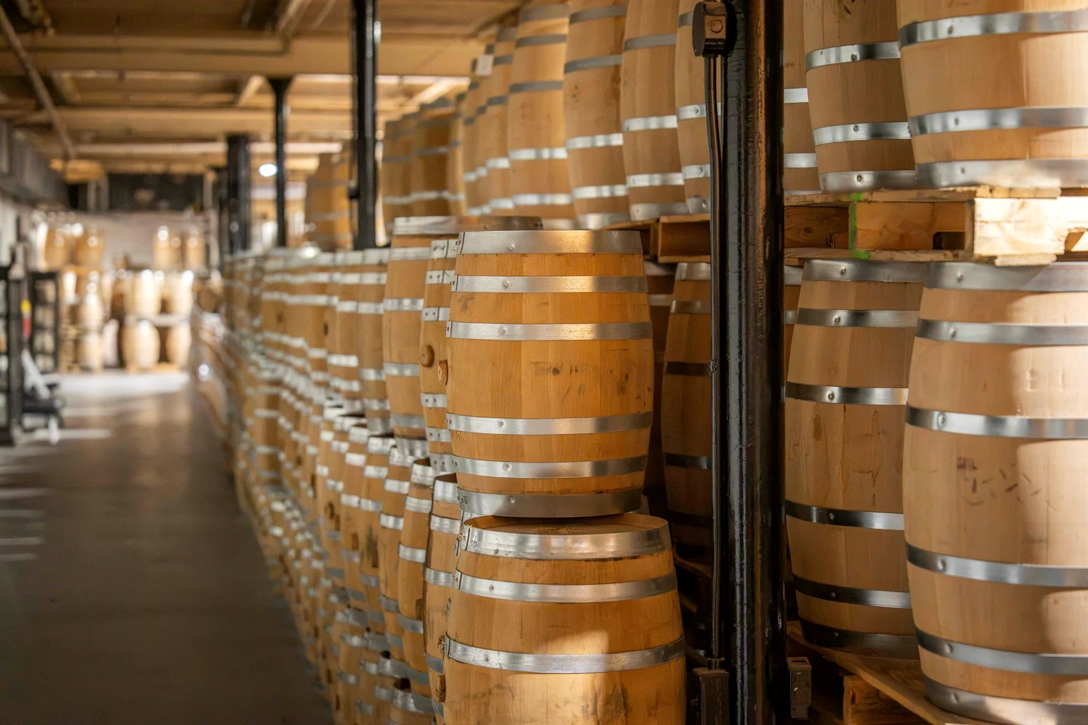 Rows of oak barrels ageing spirit in a warehouse