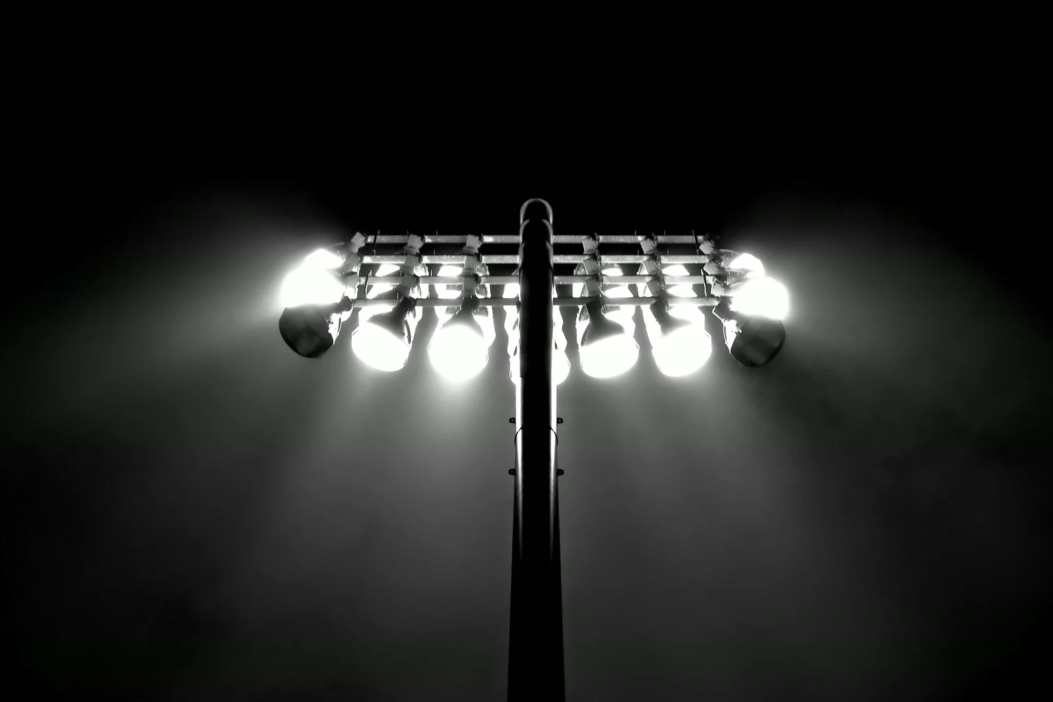 A floodlight mast lit against the night sky