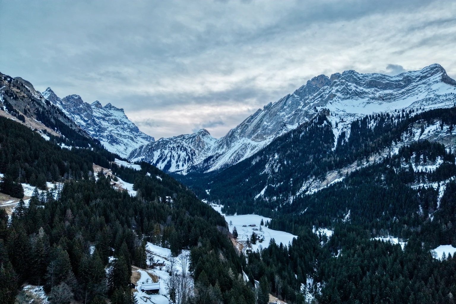 Snow-covered Alpine peaks under a clear sky