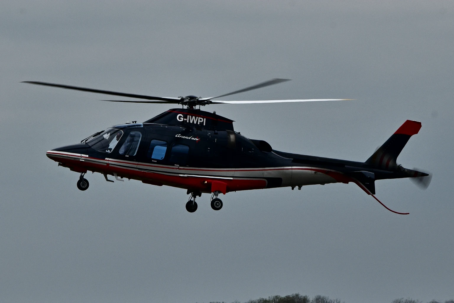 An AgustaWestland AW109SP GrandNew helicopter in flight