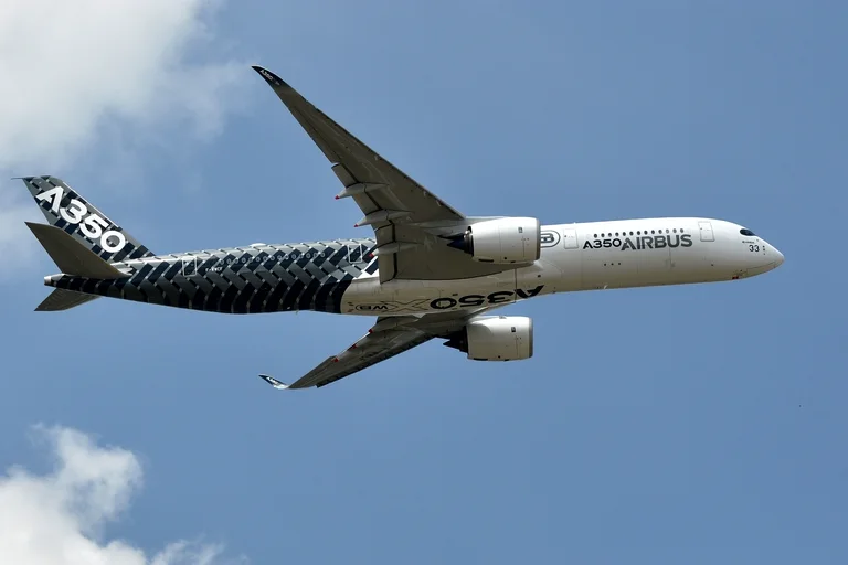 Stand-in photograph, not an ACJ350: Airbus's own A350-900 test aircraft, the airliner the ACJ350 is built from, in its carbon-weave Airbus livery, flying gear-up at the 2015 Paris Air Show.