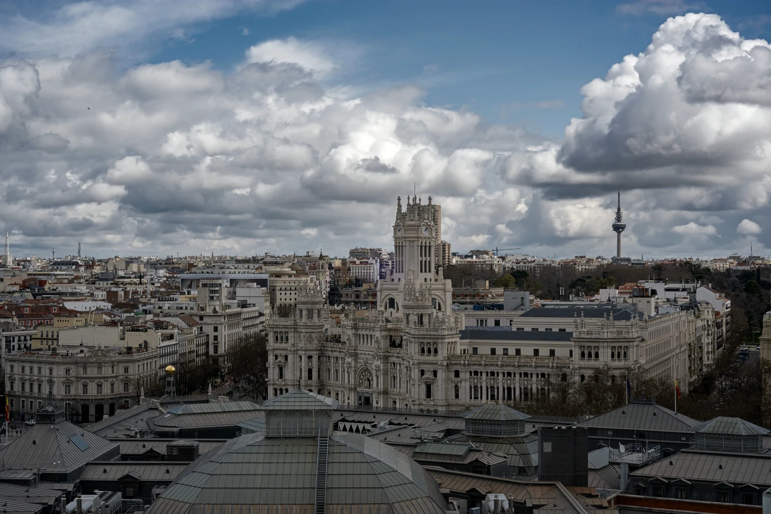 The Palacio de Cibeles and the Madrid rooftops under a cloudy sky