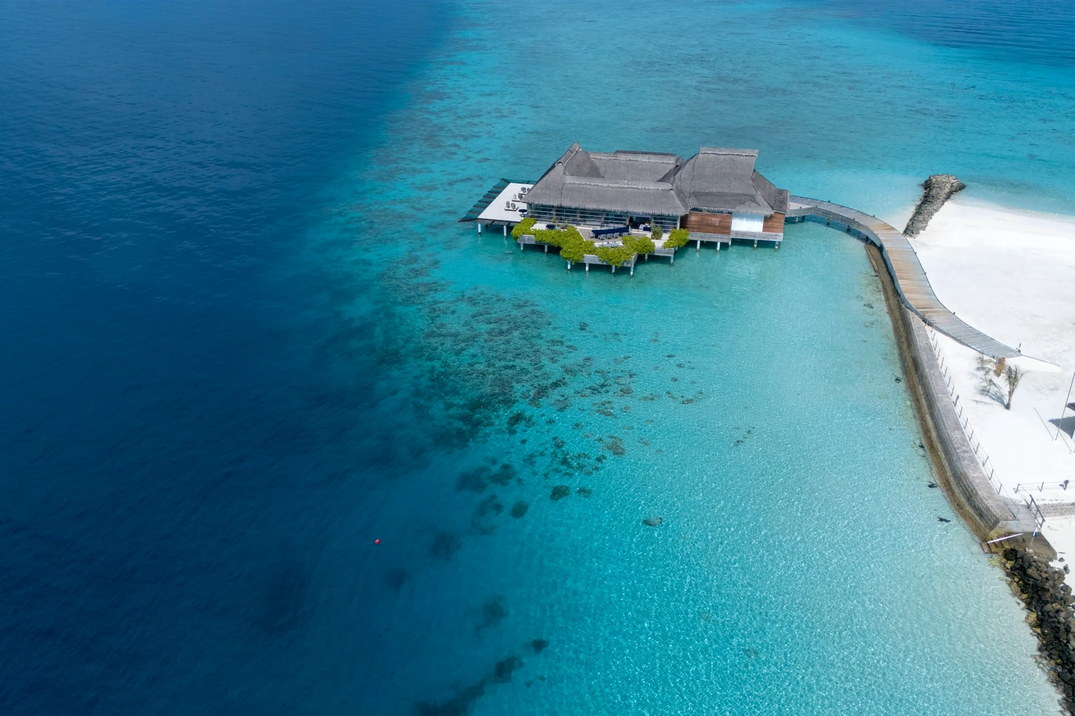 An overwater villa on a reef from the air