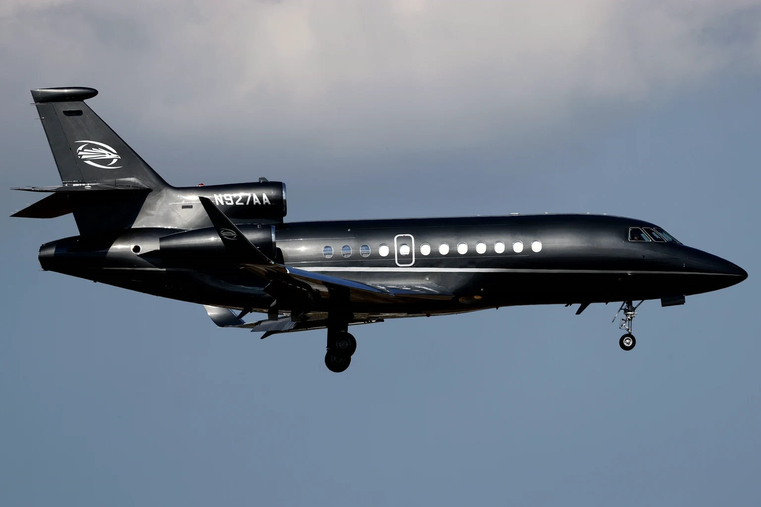 A black Dassault Falcon 900EX on final approach to Opa-locka