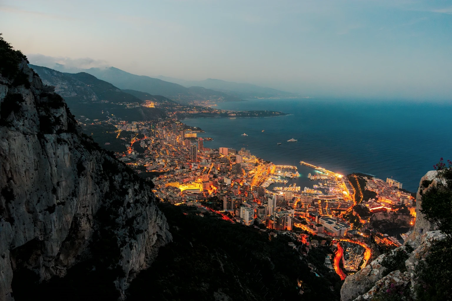 Monaco at dusk from the Tête de Chien, the harbour lit