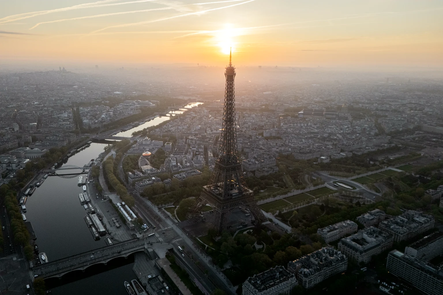 Paris from the air at sunset, the Eiffel Tower against the light