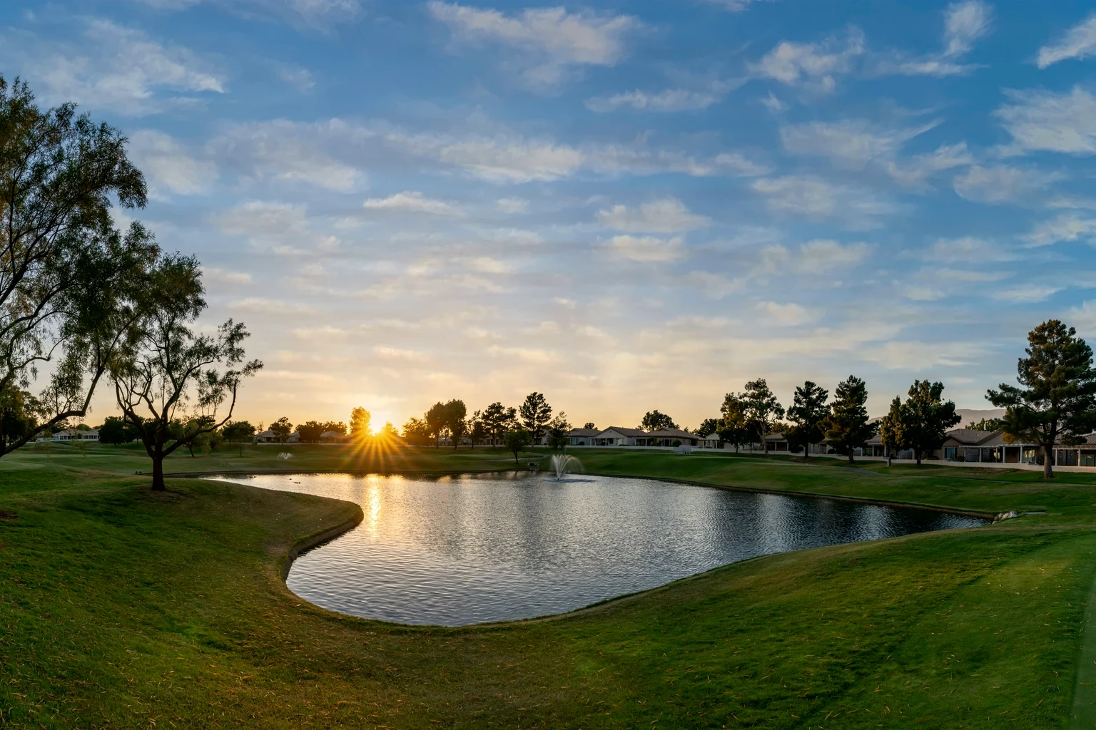A golf course lake at sunrise