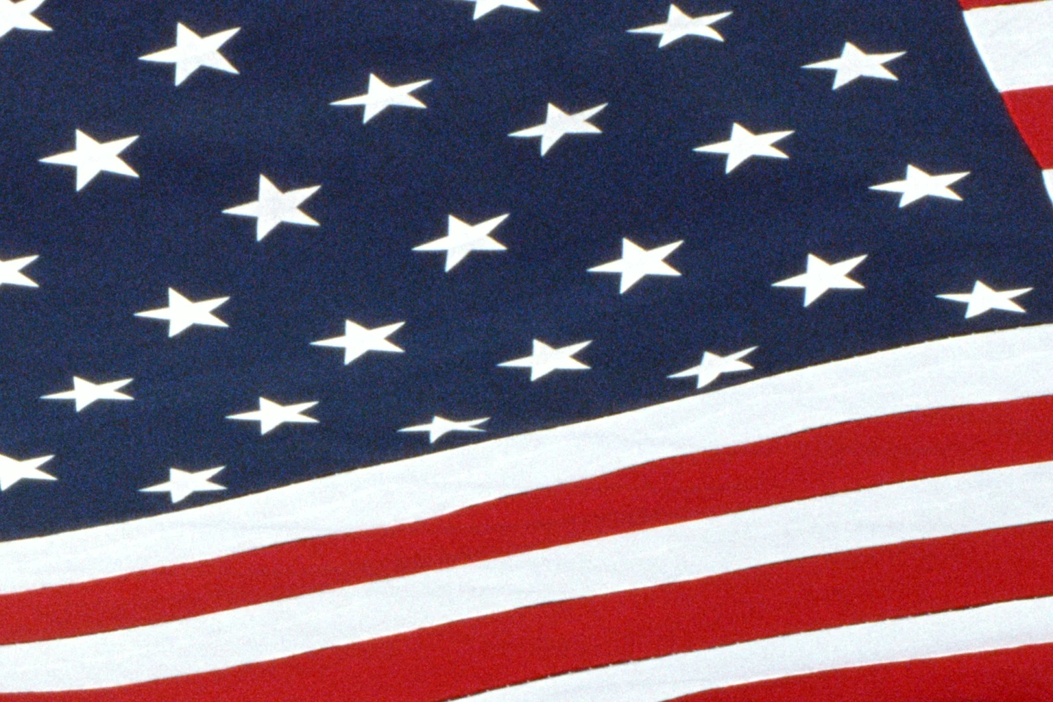 A giant American flag, stars top-left, filling the frame