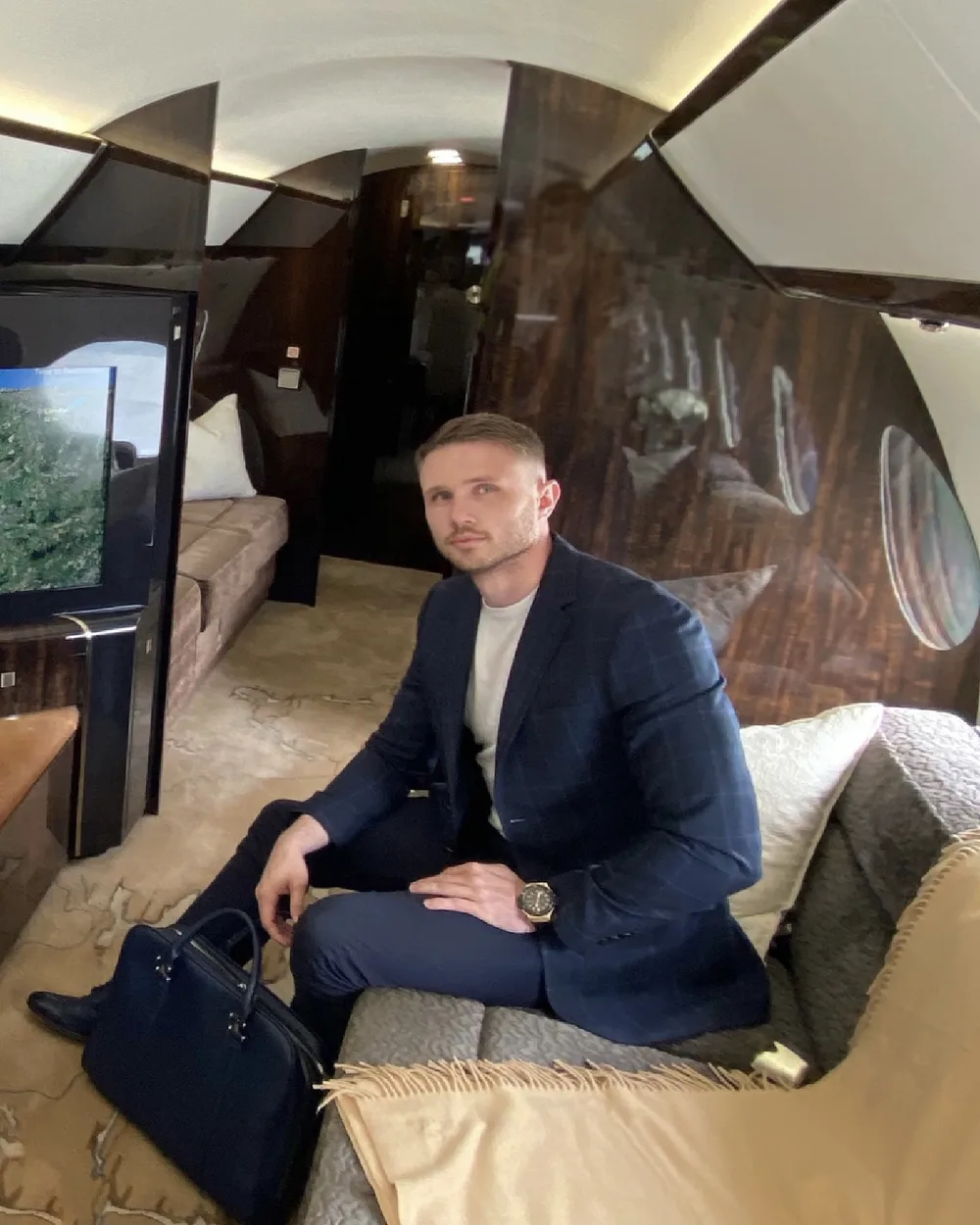 James Ison, founder of The 0.1% Group, seated in a private jet cabin