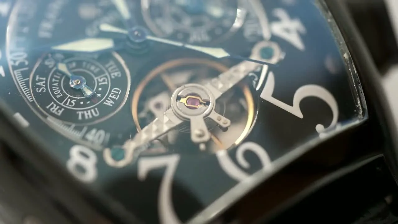 Close view of a luxury wristwatch, its dial and bracelet catching the light