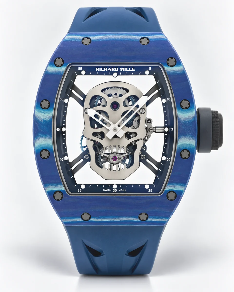 A blue Richard Mille RM 52-01 with a titanium skull forming the dial over a skeletonised tourbillon, on a blue rubber strap, photographed on white